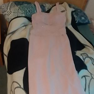 A long pink dress with a over coat